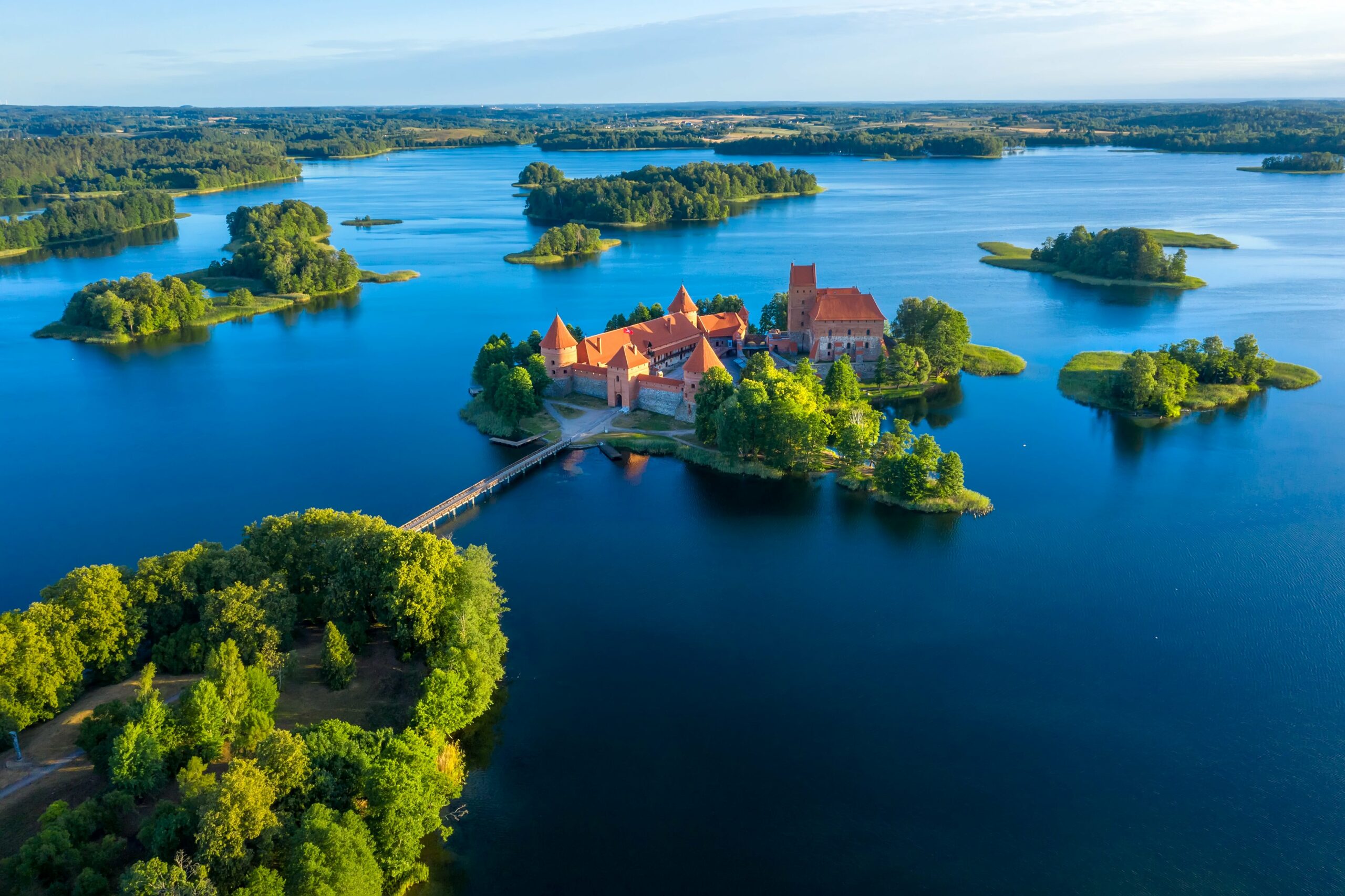 Lithuania | Smartferry | Blue lakes around old castle Trakai in Lithuania aerial view scaled