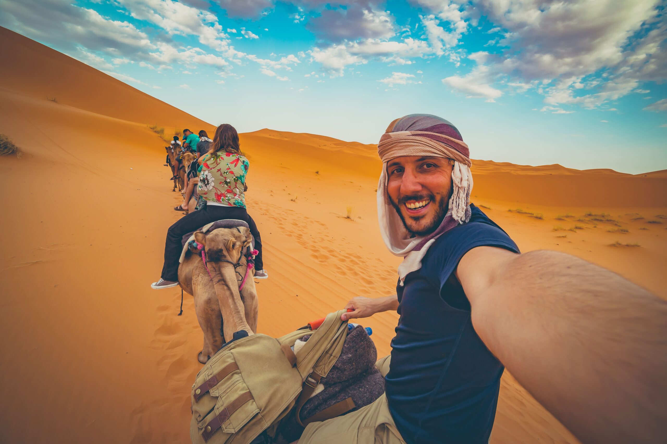 Algeria | Smartferry | happy nomad man taking crazy selfie during camel scaled